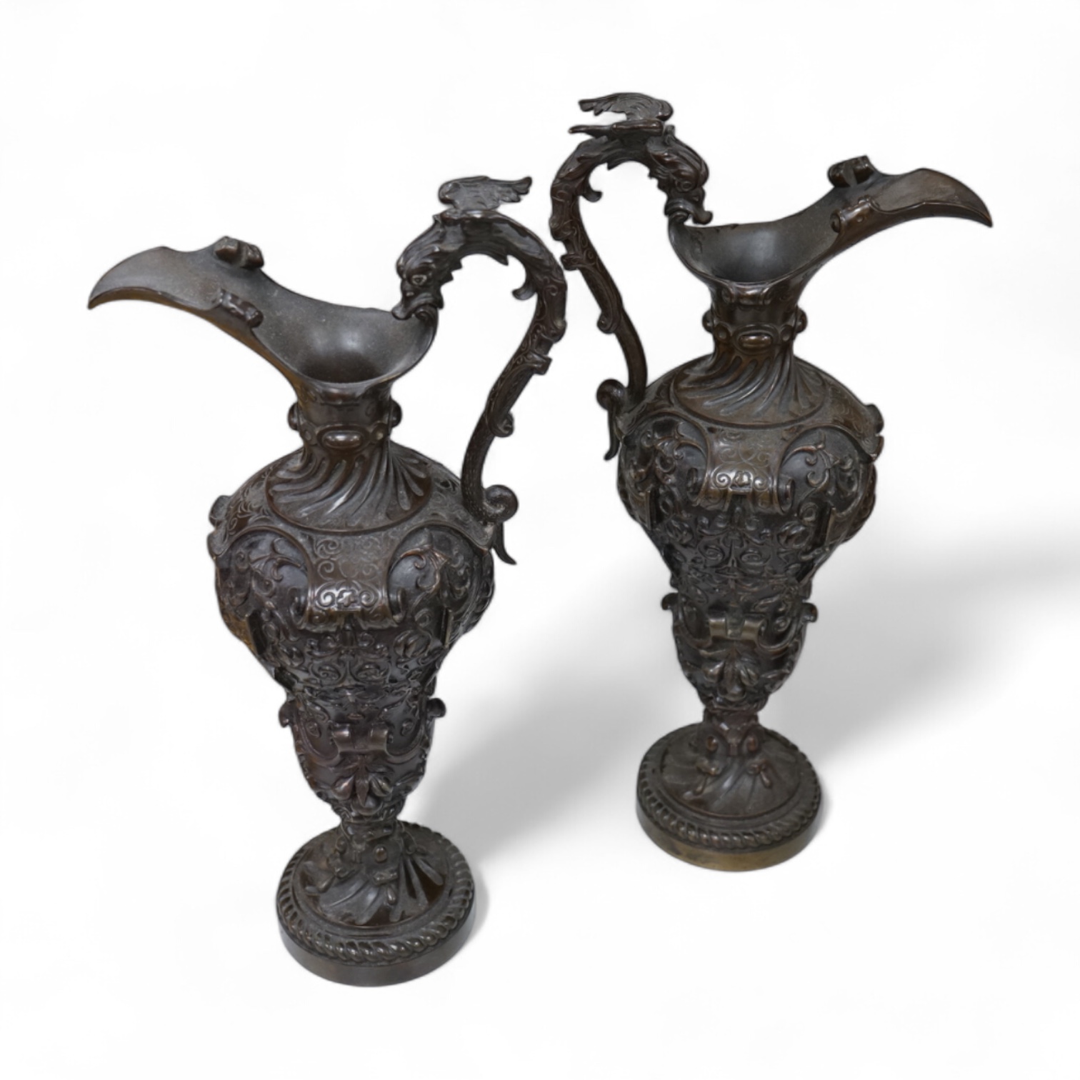 A pair of bronze pedestal ewers with dragon’s head handles, 35cm high